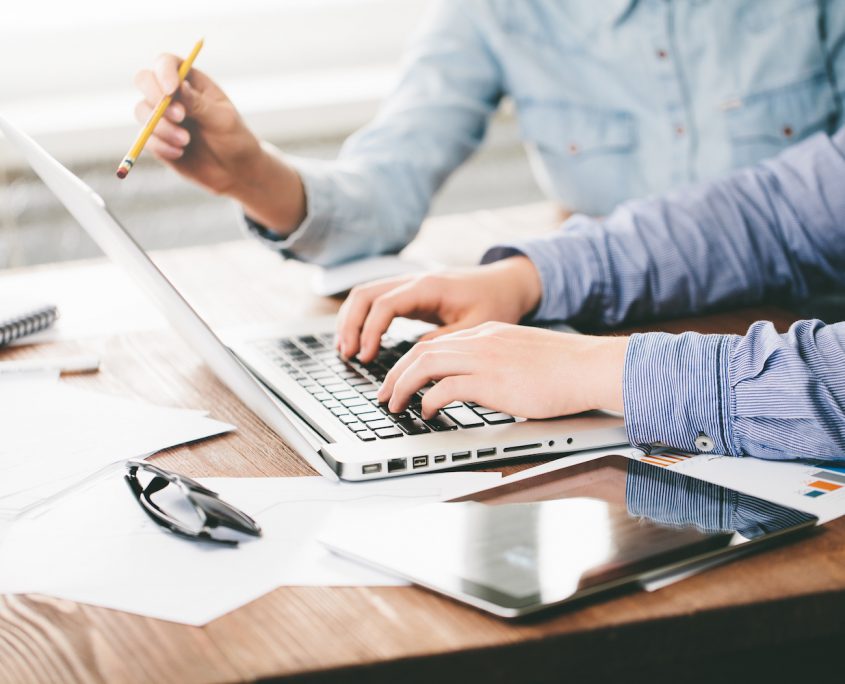 Person working on a laptop offering technical help